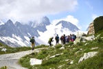 Wandergruppe vor schneebedeckten Bergen zum Oberaarsee.