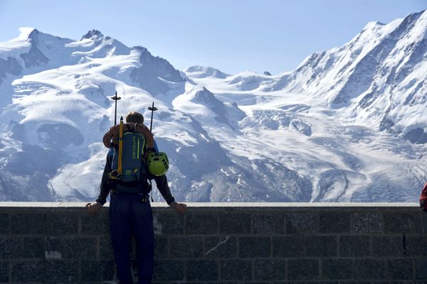 Ein Wanderer mit Seil und Schnee- und Eisausrüstung mit Blick auf die Dufourgruppe. Ein Wanderer mit Seil und Schnee- und Eisausrüstung mit Blick auf die Dufourgruppe.